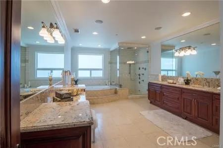 a large bathroom with a large tub and sink