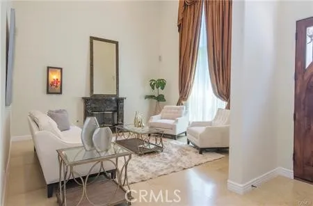 a living room with furniture a fireplace and a large window