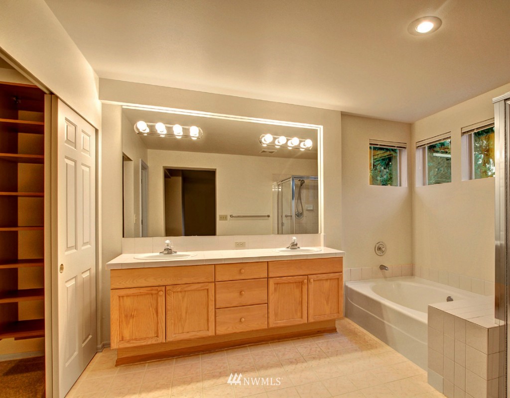 19640 88th Place Northeast Bothell, WA 98011 - Photo 13 of 15 a spacious bathroom with a tub sink shower and mirror