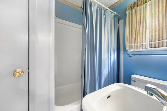 a bathroom with a bathtub and shower