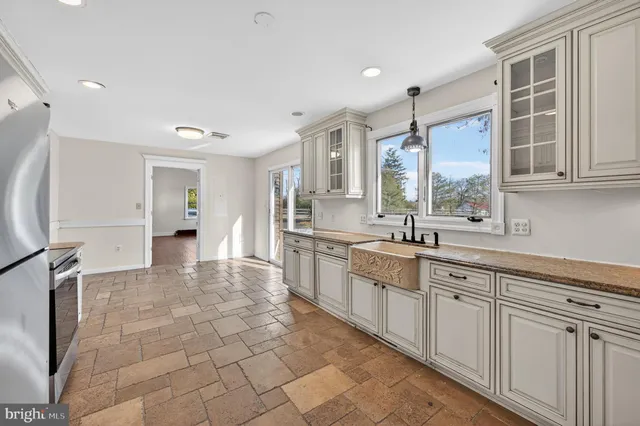 a kitchen with stainless steel appliances granite countertop a refrigerator and a stove