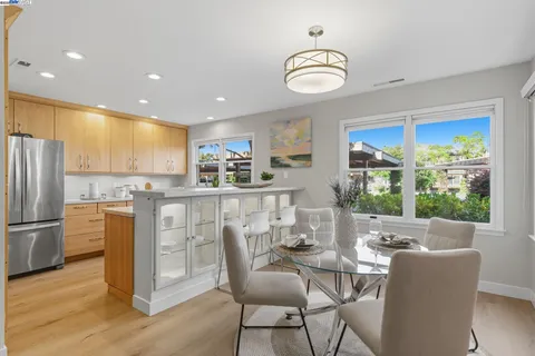 a dining room with furniture a window and wooden floor