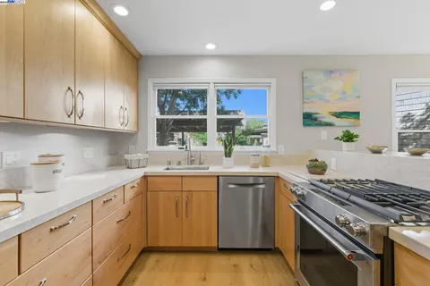 a kitchen with a sink stove and cabinets