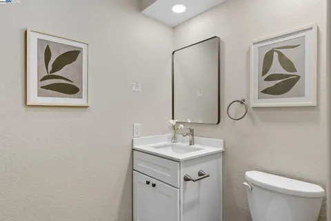 a bathroom with a toilet a sink and mirror