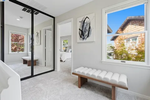 a bedroom with a bed and a painting on the wall