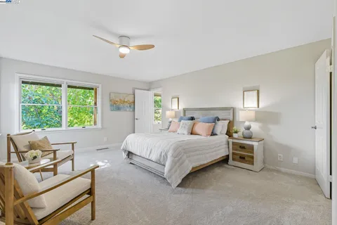 a spacious bedroom with a bed and window