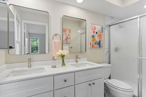 a bathroom with a sink a toilet and a mirror