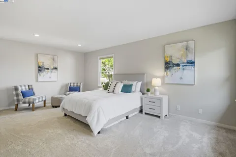 a bedroom with a bed and a couch