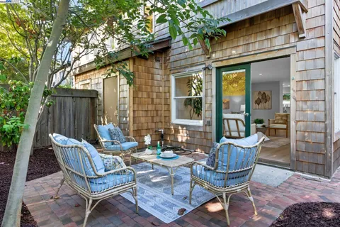 a view of a patio with couple of chairs