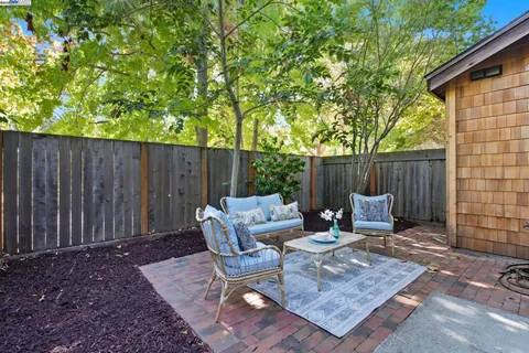 a outdoor space with patio the couch and wooden fence