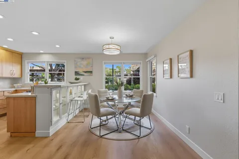 a dining room with furniture a window and wooden floor