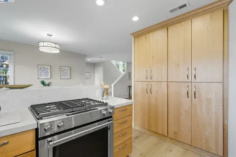 a kitchen with a stove and a refrigerator