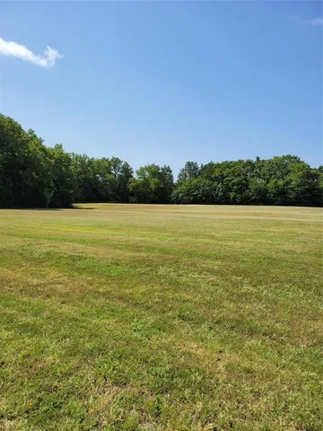 a backyard of a house with a tree
