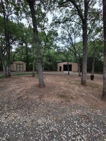 a view of a house with a yard and tree
