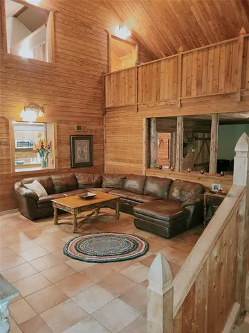 a living room with furniture a fireplace and a night stand