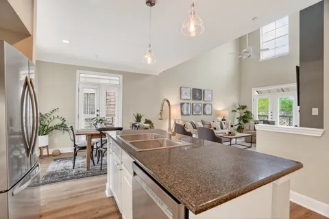 a kitchen with a table chairs and wooden floor