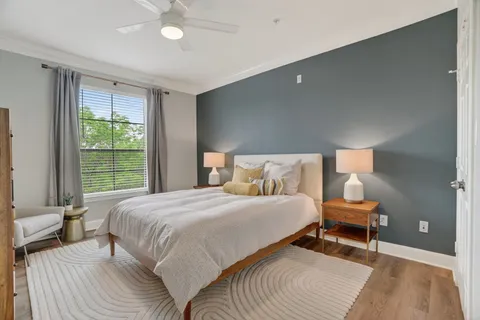 a bedroom with a bed and a window
