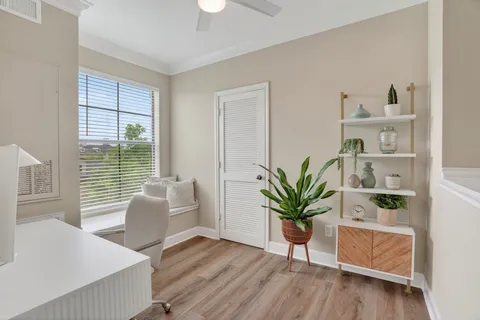 a view of living room filled with furniture and wooden floor