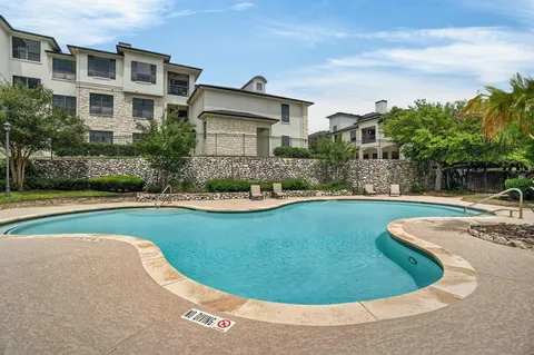 a view of a house with swimming pool and a small yard