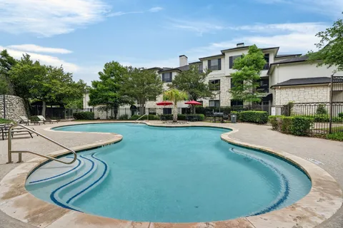 a view of a swimming pool with a yard