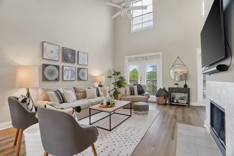 a living room with furniture fireplace and a flat screen tv