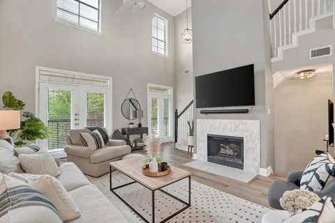a living room with furniture a fireplace and a flat screen tv