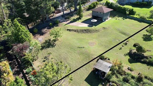 a view of a house with a yard and sitting area