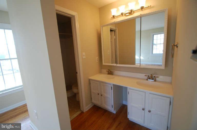 1904 Ednor Road Silver Spring, MD 20905 - Photo 15 of 30 a bathroom with a double vanity sink and mirror with window