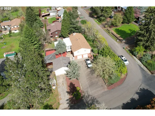an aerial view of a house with a yard and lake view