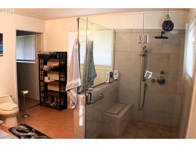 a bathroom with a toilet and a shower
