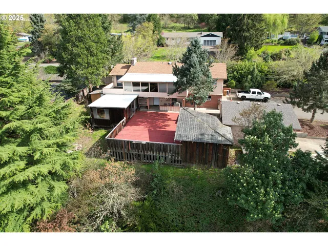 a view of a house with a yard and sitting area