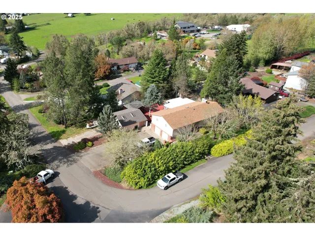 an aerial view of multiple houses with yard