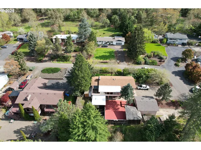 a backyard of a house with table and chairs