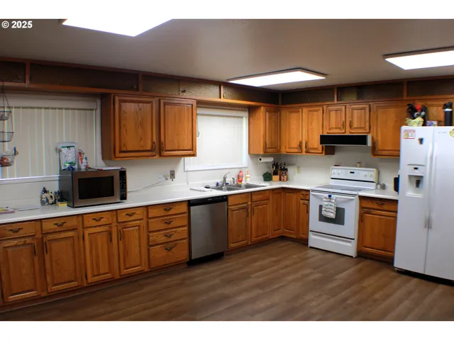 a kitchen with sink a microwave and cabinets