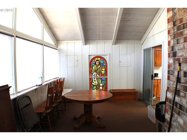 a view of a dining room with furniture and a window