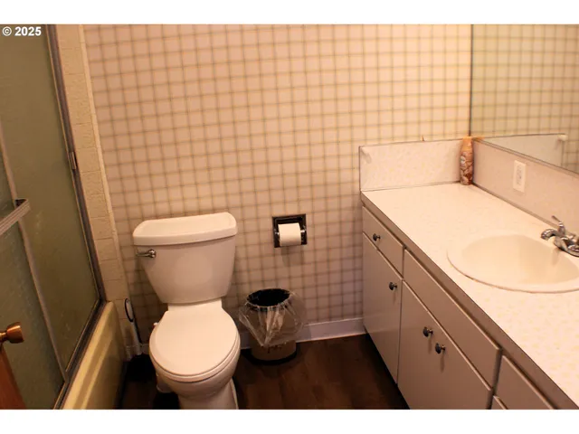 a bathroom with a toilet sink and mirror