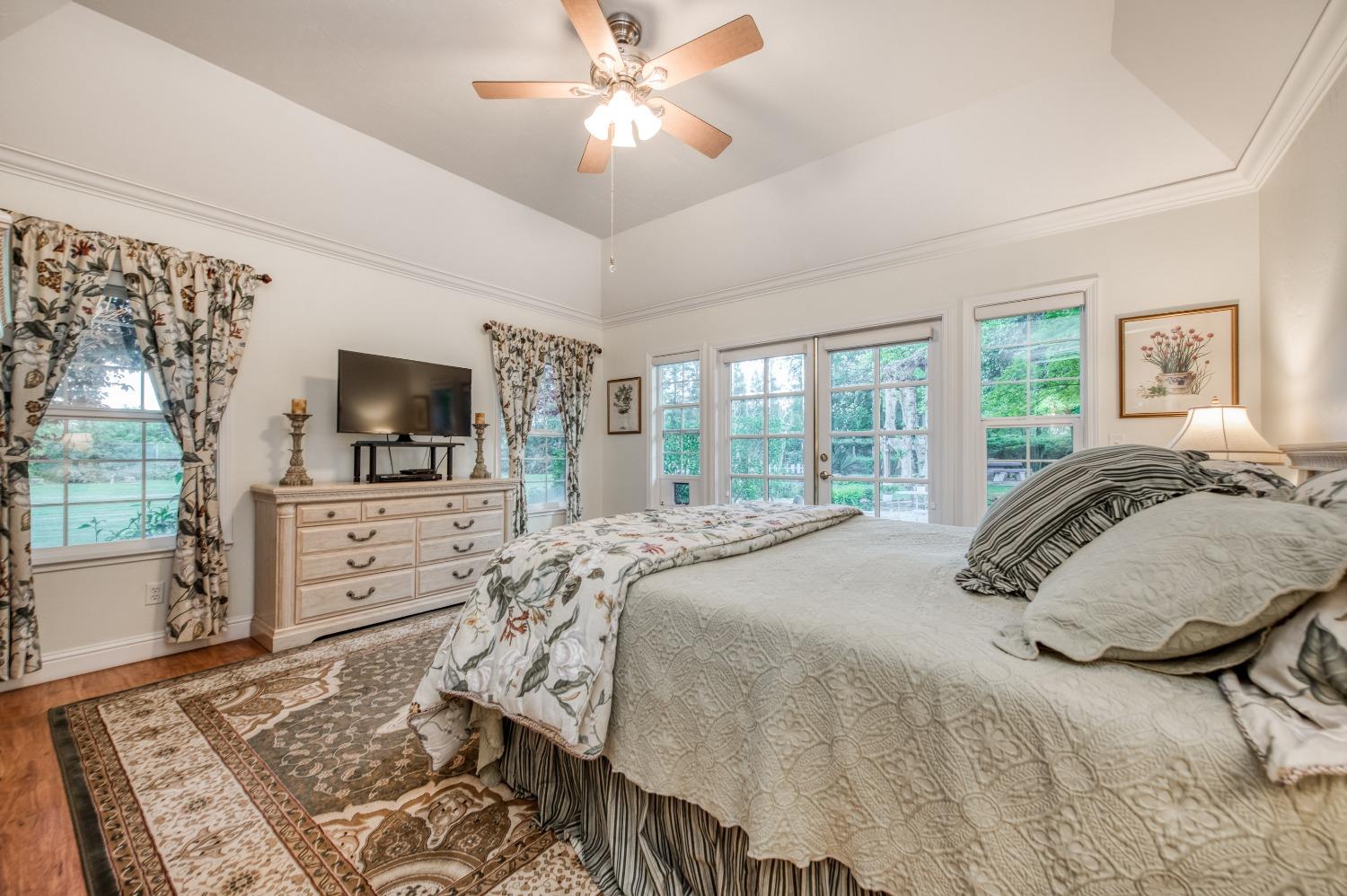 2988 Enterprise Avenue Clovis, CA 93619 - Photo 84 of 99 a bedroom with a large bed and a flat tv screen on dresser