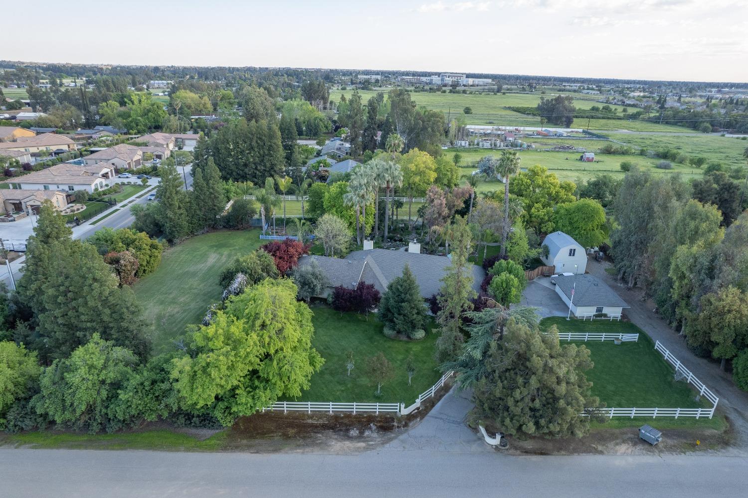 2988 Enterprise Avenue Clovis, CA 93619 - Photo 97 of 99 an aerial view of green landscape with trees houses and mountain view