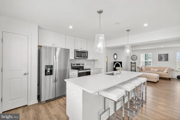 a kitchen with refrigerator cabinets and wooden floor