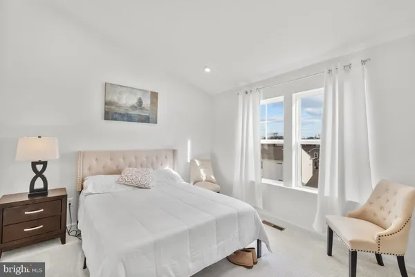 a bedroom with a bed and chair