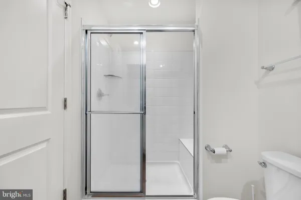 a bathroom with a glass shower door