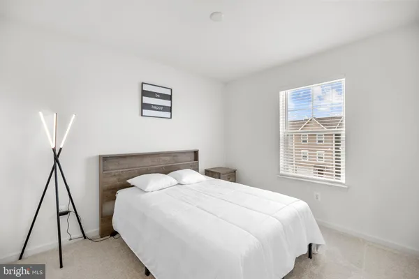 a bedroom with a bed and a night stand