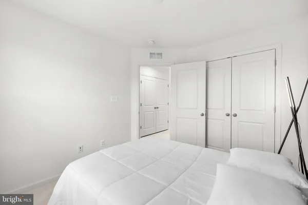 a bedroom with a bed and a closet