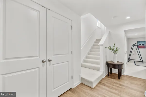 a view of entryway and hall with wooden floor