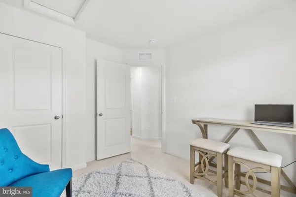 a living room with a couch and a potted plant