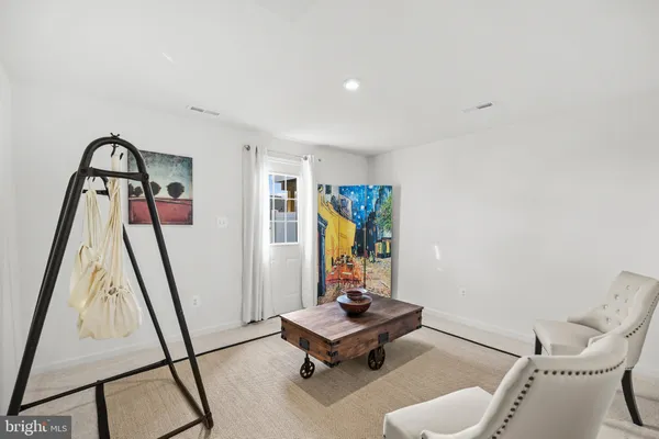 a living room with furniture and gym equipment