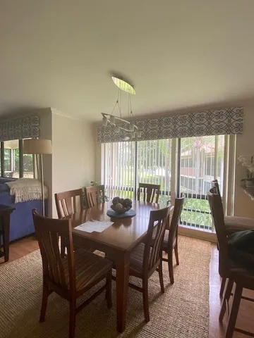 a view of a dining room with furniture window and outside view