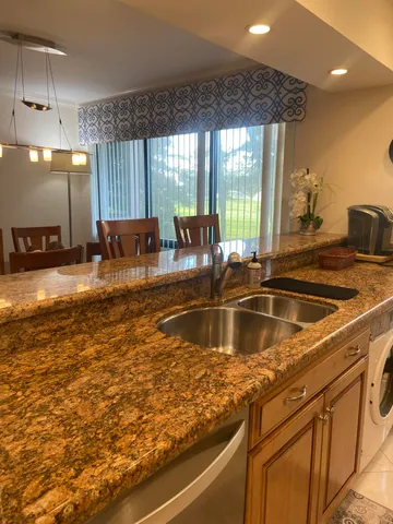 a kitchen with a sink and large window