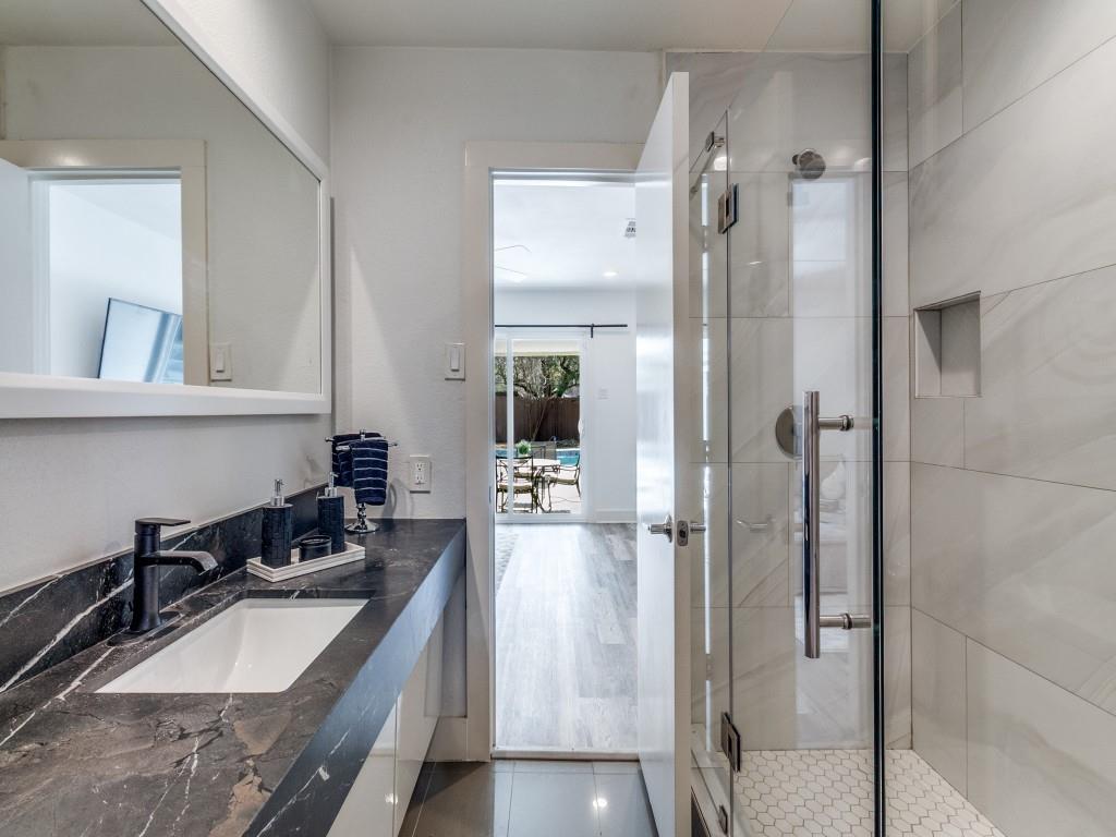 7326 Spring Valley Road Dallas, TX 75254 - Photo 21 of 25 Bathroom with a stall shower, vanity, and light tile patterned floors