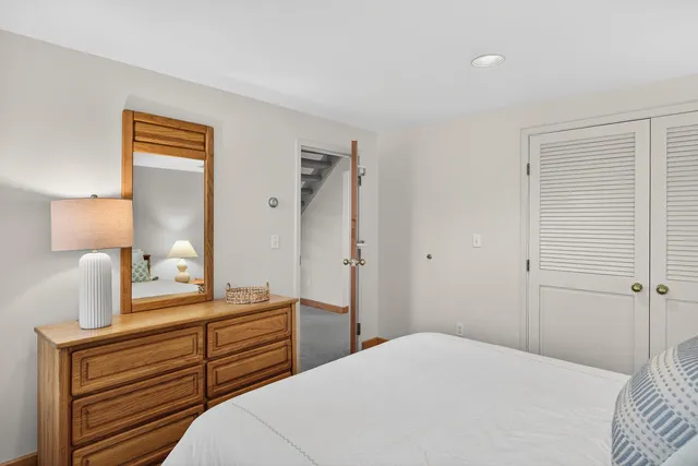 a view of a brick house with a small yard and plants